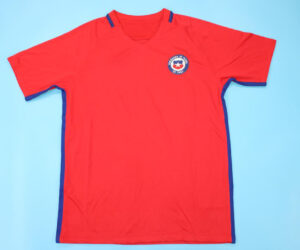 Shirt Front - Chile 2016-2017 Home Short-Sleeve Jersey Throughout the season, Chile maintained a formidable presence, showcasing their trademark grit and determination in every match they contested. Led by the experienced and inspirational Claudio Bravo, the team exhibited resilience and skill, proving themselves as worthy contenders in every competition they entered. In the Copa América Centenario, held in 2016 to commemorate the tournament's centennial anniversary, Chile embarked on a journey to defend their title. Facing stiff competition from formidable opponents, including perennial rivals Argentina, Chile once again displayed their mettle in a thrilling final showdown. Despite their historic inability to defeat Argentina in regular time, Chile triumphed in a tense penalty shootout, clinching their second consecutive Copa América title and etching their name in the annals of footballing history. Beyond the Copa América, Chile continued to assert their dominance in various international competitions, with notable performances from key players such as Alexis Sánchez, Arturo Vidal, and Eduardo Vargas. Their unwavering commitment to excellence and their never-say-die attitude propelled them to success, earning the admiration of fans worldwide and solidifying their status as a footballing powerhouse in South America. As the season drew to a close, Chile emerged as one of the continent's most formidable teams, with their sights set on future triumphs and further glory on the international stage.